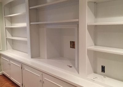 spraying paint on built in cabinets