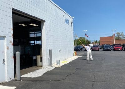 exterior painting crew painting car dealership
